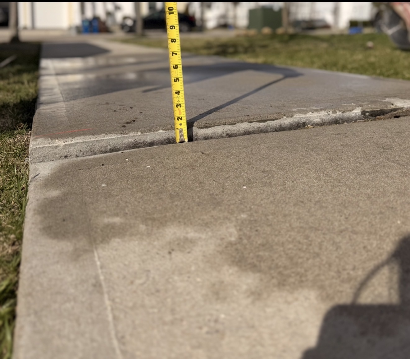 Sunken concrete before lifting - tape measure showing gap
