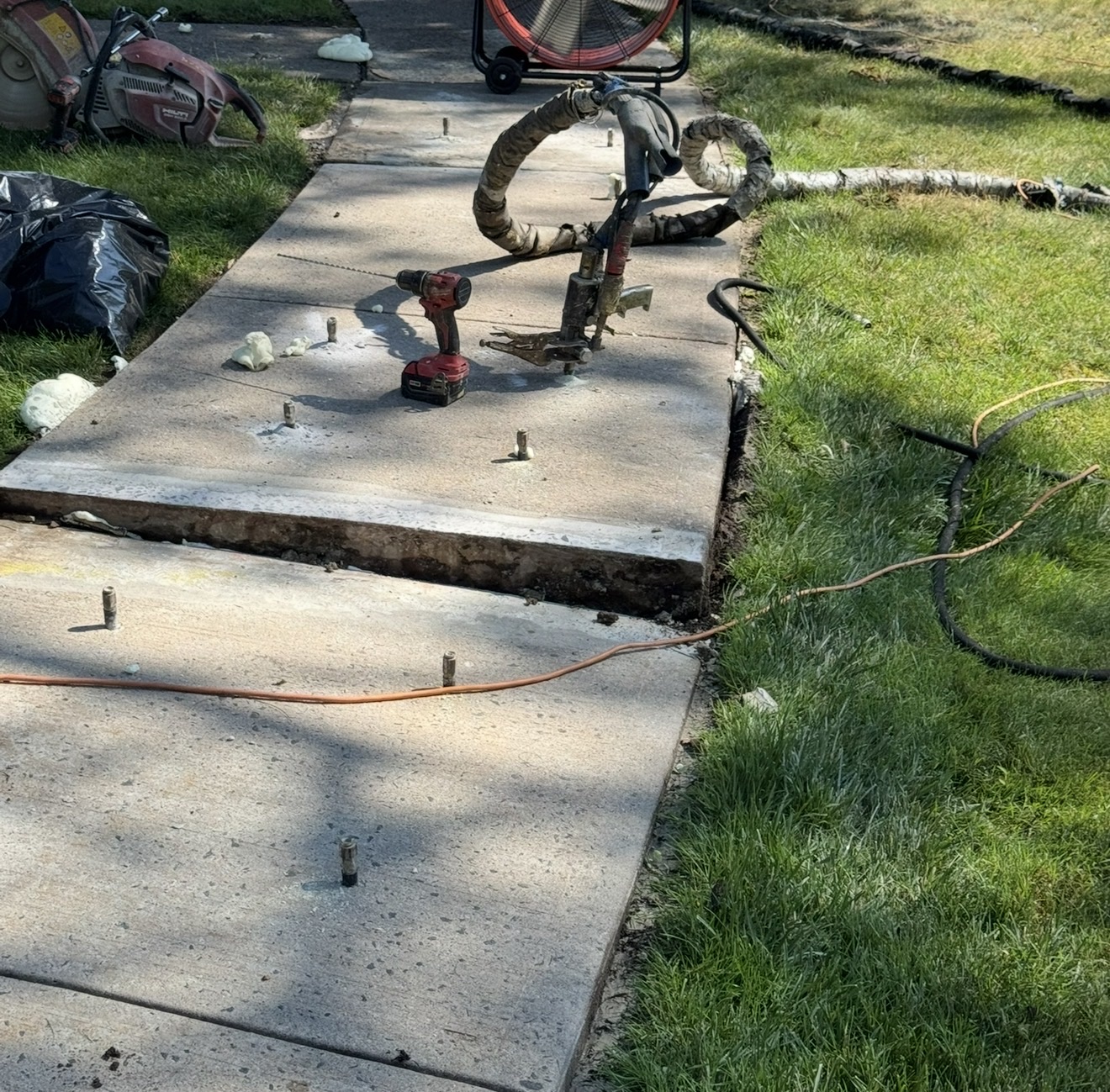 Polyjacking equipment on concrete sidewalk